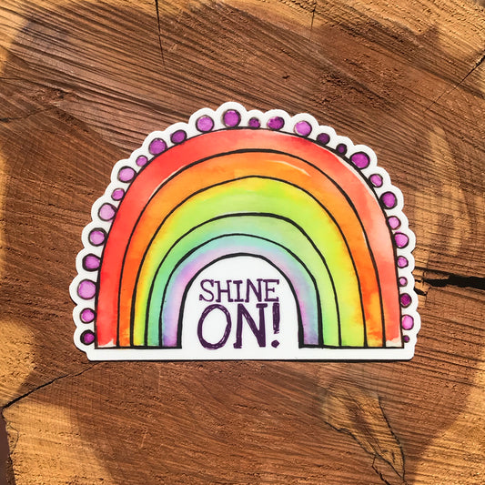 Rainbow sticker with the words Shine On