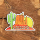 Arizona sticker with sandstone butte, saguaro cactus, sunset, and howling coyote