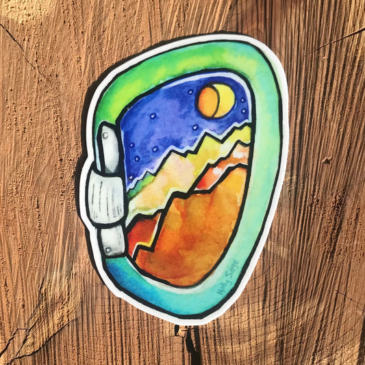 A carabiner sticker with rugged mountains inside