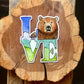 LOVE statue sticker with a grizzly bear in place of the O