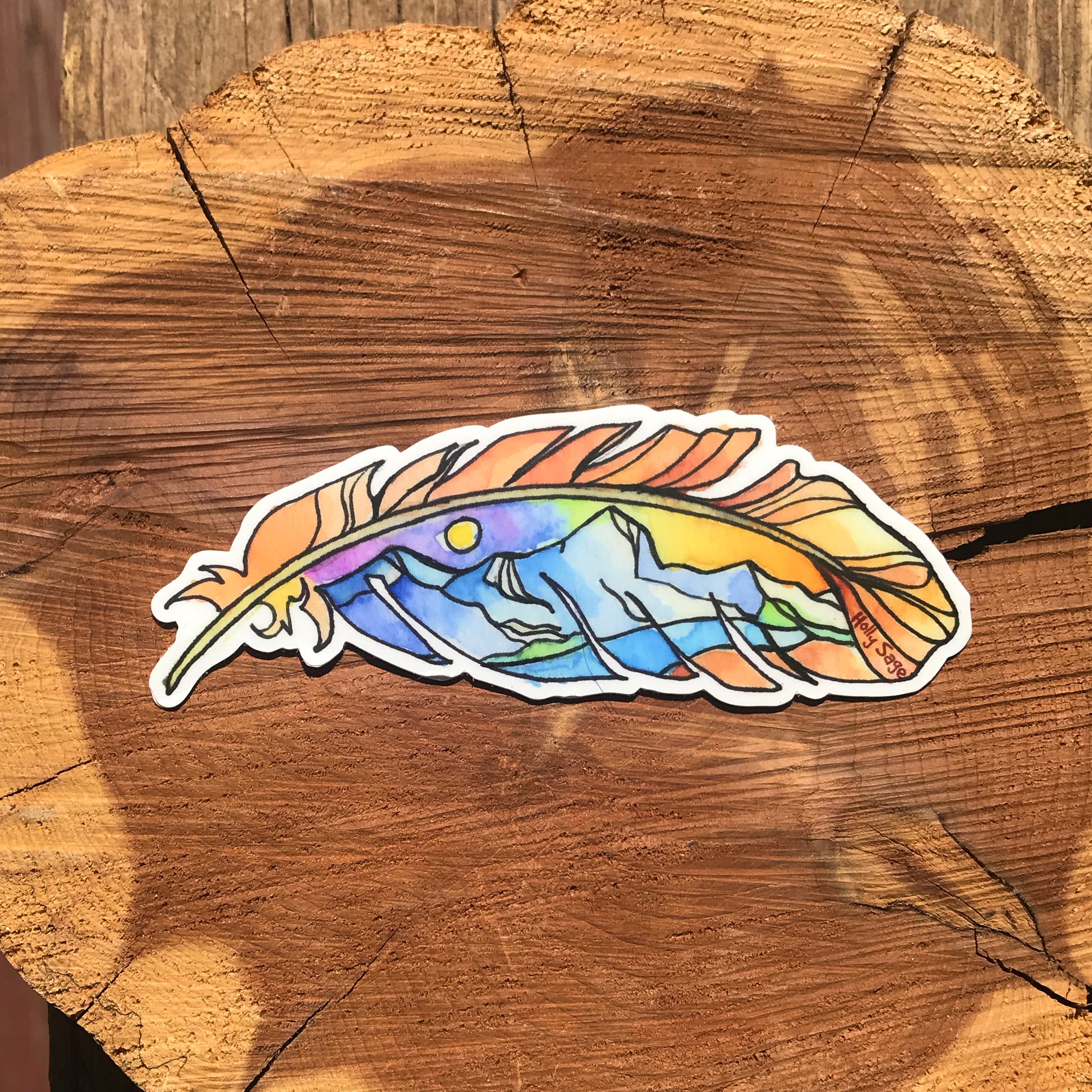 Mountain landscape at sunset inside a feather outline sticker